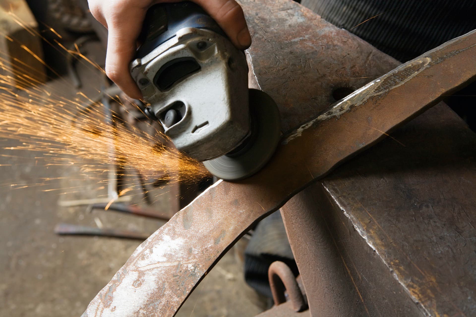 Grinding wheel throwing sparks on industrial metal